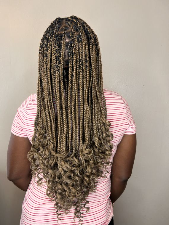 Ash-blonde box braids finished with curled ends